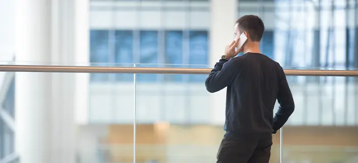 a man making a phone call, possibly representing whistleblowing or reporting misconduct.