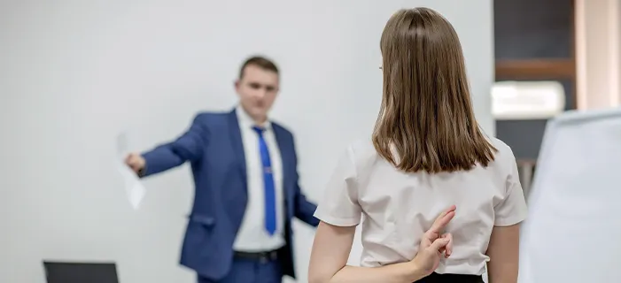 a man making unwanted advances towards a woman, symbolizing sexual harassment in the workplace